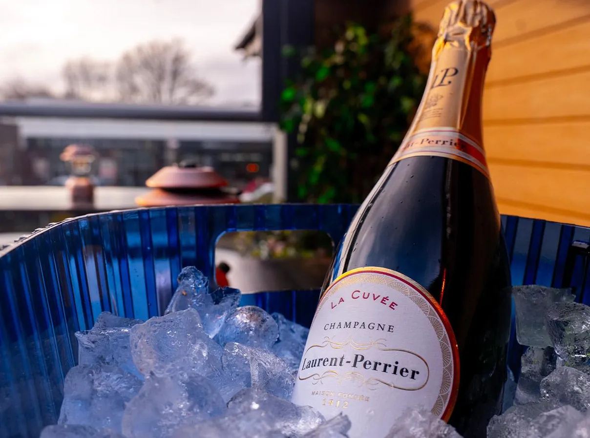 A bottle of Laurent-Perrier on ice on the rooftop